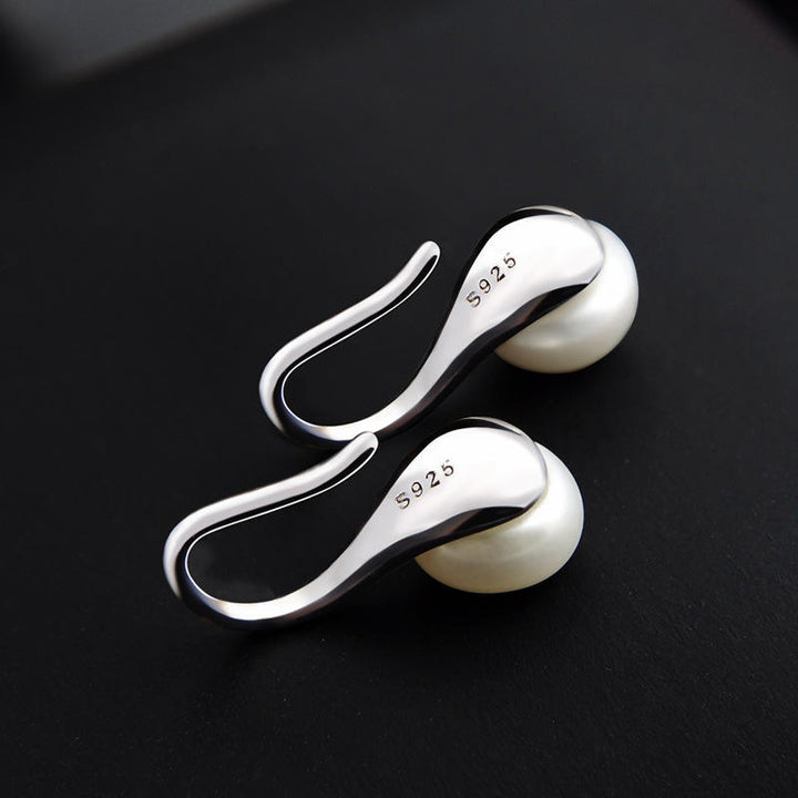 Oorbellen met schelp en parel